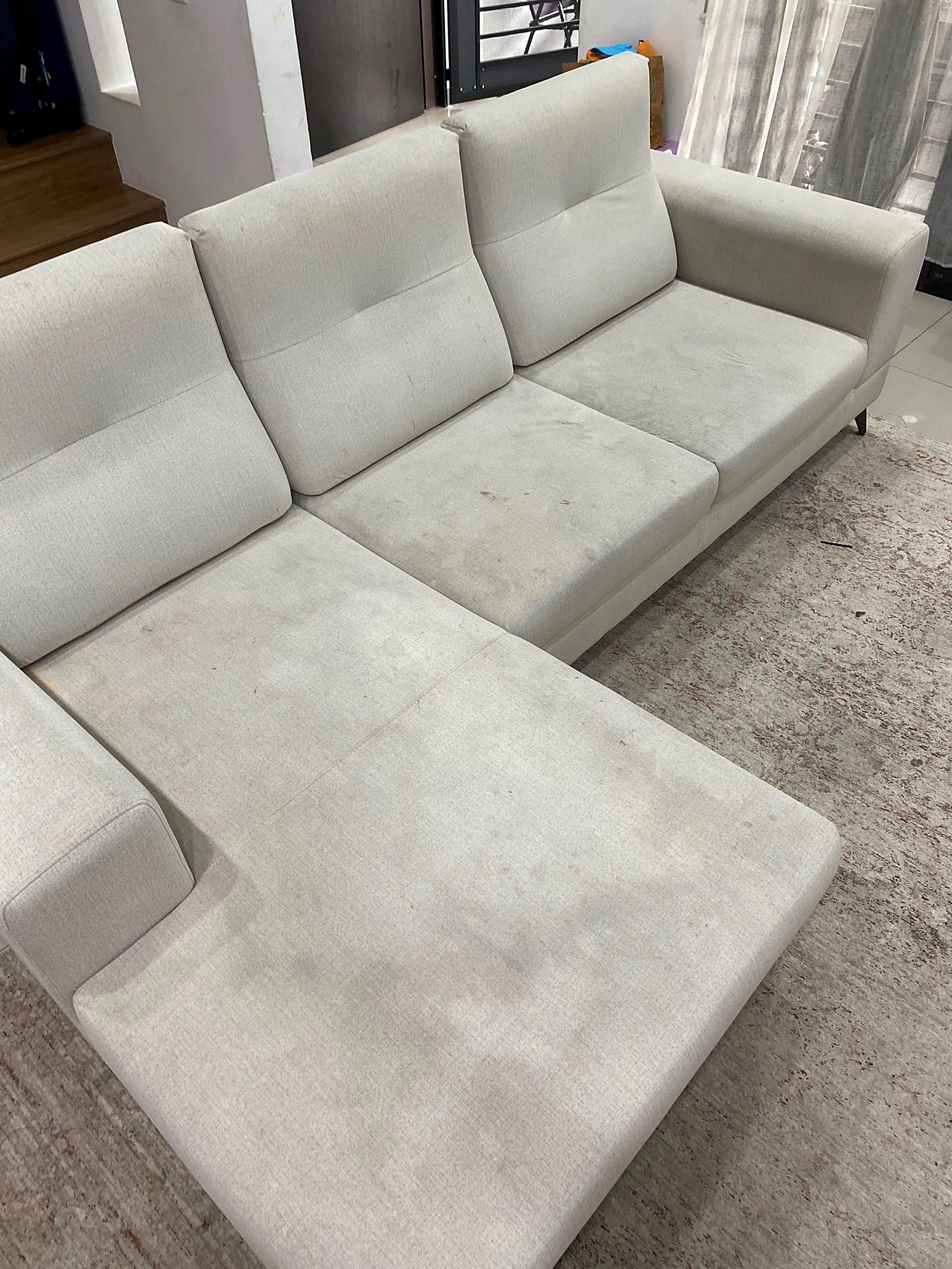 L-shaped sofa — before cleaning